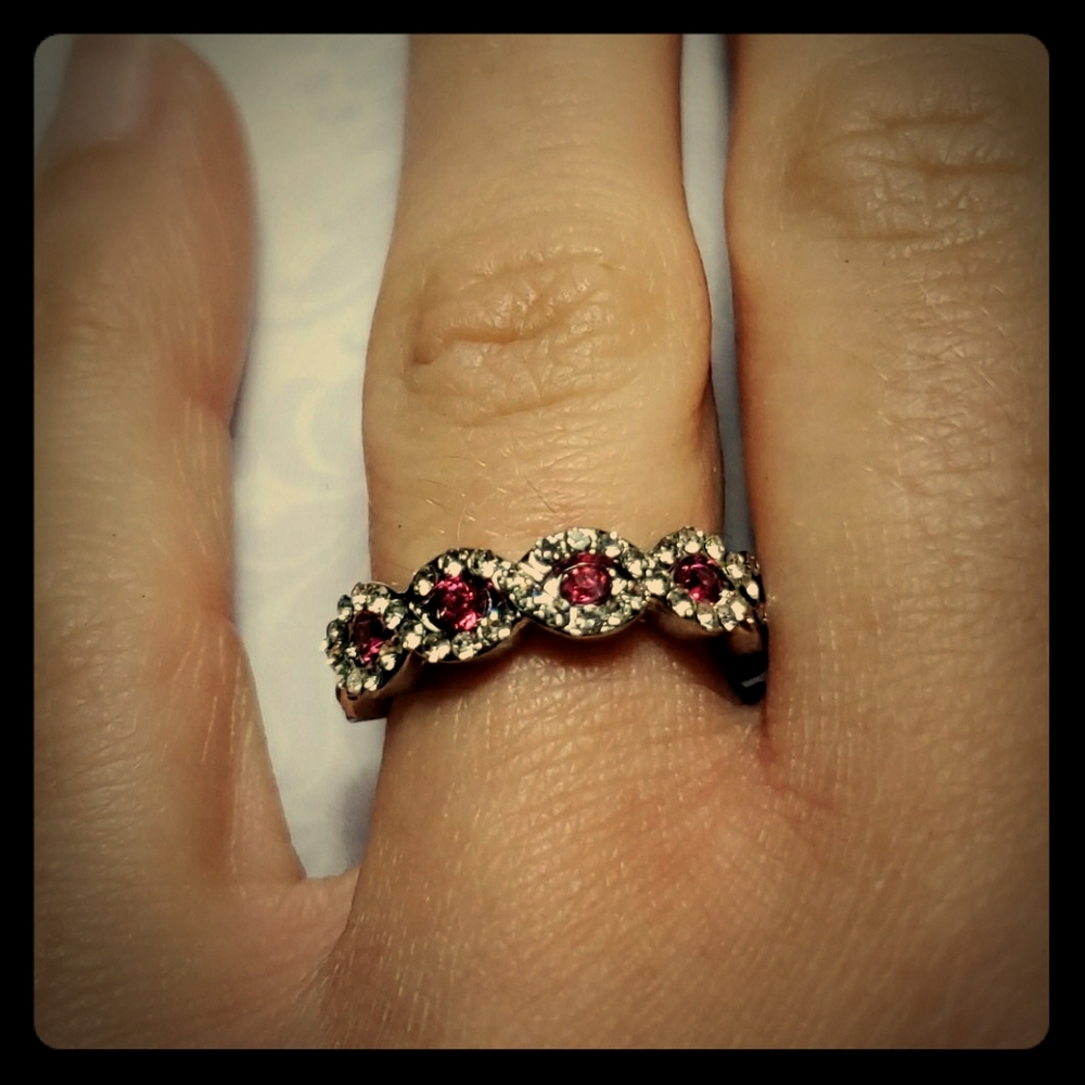 Beautiful  sliver ring with pink gemstones.